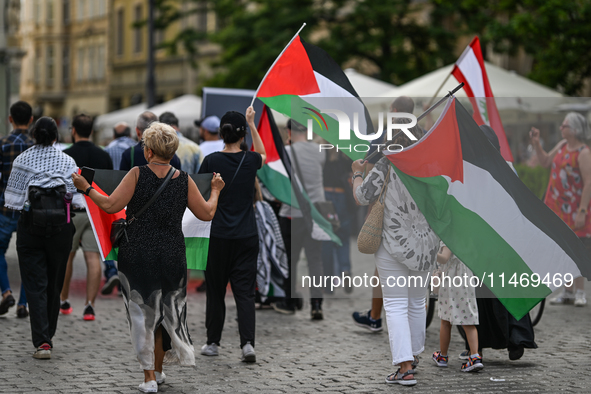 KRAKOW, POLAND - AUGUST 10:
Pro-Palestinian activists rally in Krakow's UNESCO-listed Old Town during the 'March for Palestine,' advocating...