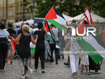 KRAKOW, POLAND - AUGUST 10:
Pro-Palestinian activists rally in Krakow's UNESCO-listed Old Town during the 'March for Palestine,' advocating...