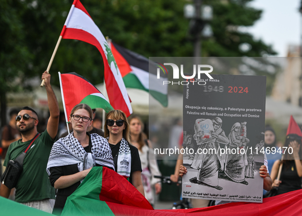 KRAKOW, POLAND - AUGUST 10:
Pro-Palestinian activists rally in Krakow's UNESCO-listed Old Town during the 'March for Palestine,' advocating...