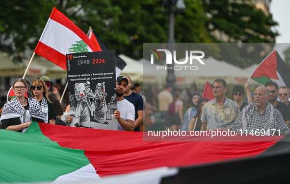 KRAKOW, POLAND - AUGUST 10:
Pro-Palestinian activists rally in Krakow's UNESCO-listed Old Town during the 'March for Palestine,' advocating...