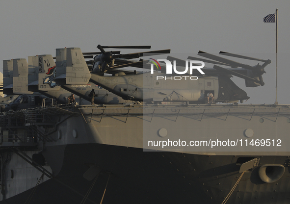 Crew members stand aboard the amphibious assault ship USS Wasp (LHD-1) docked at Limassol Port, amid rising tensions in the Middle East, in...