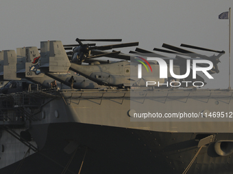 Crew members stand aboard the amphibious assault ship USS Wasp (LHD-1) docked at Limassol Port, amid rising tensions in the Middle East, in...