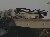 Crew members stand aboard the amphibious assault ship USS Wasp (LHD-1) docked at Limassol Port, amid rising tensions in the Middle East, in...