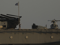 Crew members stand aboard the amphibious assault ship USS Wasp (LHD-1) docked at Limassol Port, amid rising tensions in the Middle East, in...