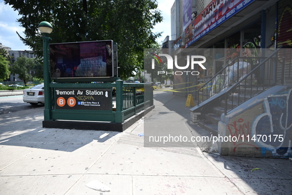 Blood is on the sidewalk and steps outside of the Tremont Av station. Two men are being slashed outside of the Tremont Avenue subway station...