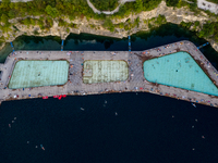 An aerial view of people refreshing and sunbathing during a warm evening in Zakrzowek, a popular resort in Krakow, Poland on August 11, 2024...