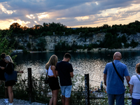 People watch a sunset during a warm evening in Zakrzowek, a popular resort in Krakow, Poland on August 11, 2024. According to the EU's clima...