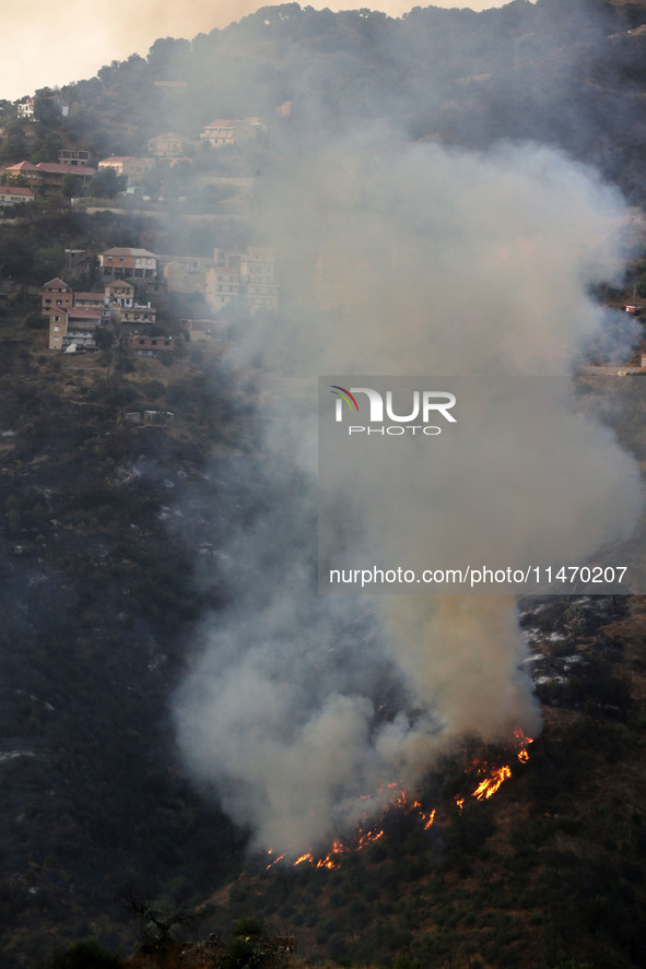 A forest fire is burning near the village of Larbaa Nath Reten, Tizi Ouzou, in the mountainous region of Kabyle, Algeria, on August 11, 2024...