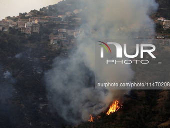 A forest fire is burning near the village of Larbaa Nath Reten, Tizi Ouzou, in the mountainous region of Kabyle, Algeria, on August 11, 2024...