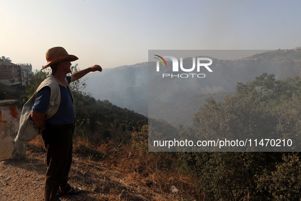 A forest fire is burning near the village of Larbaa Nath Reten, Tizi Ouzou, in the mountainous region of Kabyle, Algeria, on August 11, 2024...