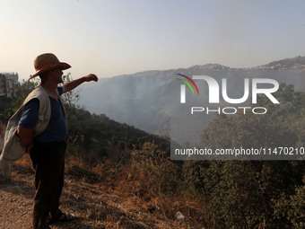 A forest fire is burning near the village of Larbaa Nath Reten, Tizi Ouzou, in the mountainous region of Kabyle, Algeria, on August 11, 2024...