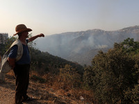 A forest fire is burning near the village of Larbaa Nath Reten, Tizi Ouzou, in the mountainous region of Kabyle, Algeria, on August 11, 2024...