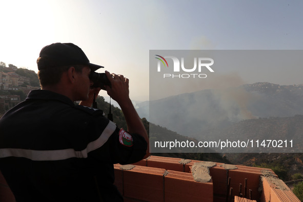 A forest fire is burning near the village of Larbaa Nath Reten, Tizi Ouzou, in the mountainous region of Kabyle, Algeria, on August 11, 2024...