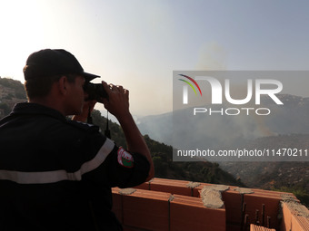 A forest fire is burning near the village of Larbaa Nath Reten, Tizi Ouzou, in the mountainous region of Kabyle, Algeria, on August 11, 2024...