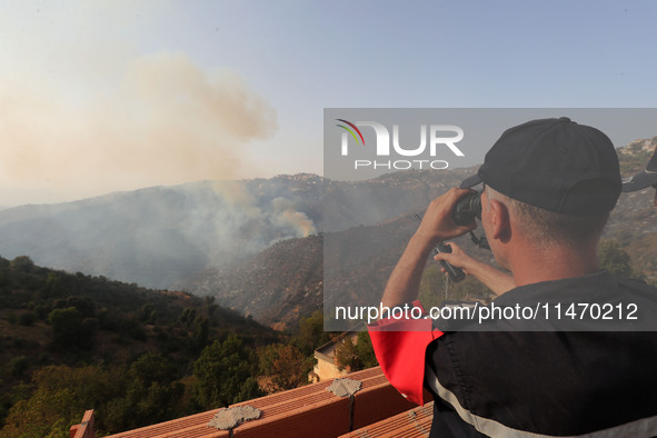 A forest fire is burning near the village of Larbaa Nath Reten, Tizi Ouzou, in the mountainous region of Kabyle, Algeria, on August 11, 2024...