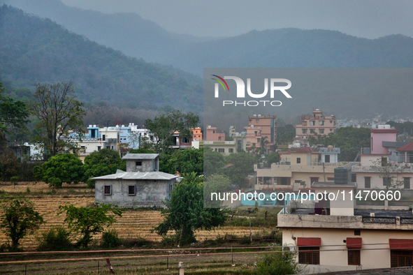 Houses are standing in a rural area just outside the town of Haldwani, Uttarakhand, India, on April 23, 2024. 