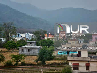 Houses are standing in a rural area just outside the town of Haldwani, Uttarakhand, India, on April 23, 2024. (