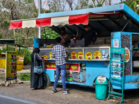 People are ordering food at a food cart along the roadside in Haldwani, Uttarakhand, India, on April 23, 2024. (