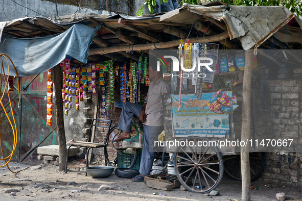 A man is selling packets of snuff and dried snacks along the roadside in Haldwani, Uttarakhand, India, on April 23, 2024. 