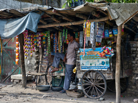 A man is selling packets of snuff and dried snacks along the roadside in Haldwani, Uttarakhand, India, on April 23, 2024. (