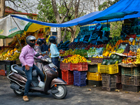 People are buying fresh fruit at a fruit stand along the roadside in Haldwani, Uttarakhand, India, on April 23, 2024. (