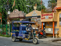 An auto-rickshaw is traveling along the road in Haldwani, Uttarakhand, India, on April 23, 2024. (