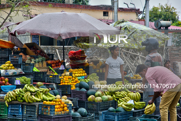 People are buying fresh fruit at a fruit stand along the roadside in Haldwani, Uttarakhand, India, on April 23, 2024. 