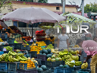 People are buying fresh fruit at a fruit stand along the roadside in Haldwani, Uttarakhand, India, on April 23, 2024. (