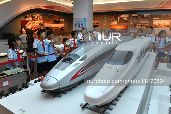 Primary school children are viewing models of the Fuxing and Harmony high-speed trains at Jiaoji Railway Museum in Qingdao, Shandong provinc...