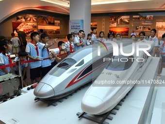 Primary school children are viewing models of the Fuxing and Harmony high-speed trains at Jiaoji Railway Museum in Qingdao, Shandong provinc...