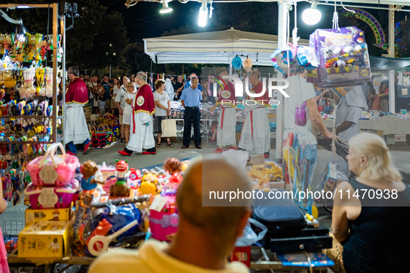 The procession of the Three Saints of Bisceglie is taking place amidst the stalls in Bisceglie, Italy, on August 11, 2024. Bisceglie is cele...