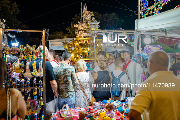 The procession of the Three Saints of Bisceglie is taking place amidst the stalls in Bisceglie, Italy, on August 11, 2024. Bisceglie is cele...