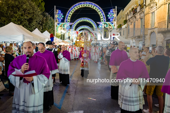 Bishops and priests are participating in the procession of the Three Saints of Bisceglie in the town centre, in Bisceglie, on August 11, 202...