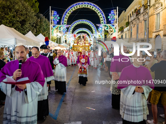 Bishops and priests are participating in the procession of the Three Saints of Bisceglie in the town centre, in Bisceglie, on August 11, 202...