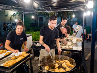 A boy is frying panzerotti for sale during the patronal feast of the Three Saints of Bisceglie, in Bisceglie, on August 11, 2024. Bisceglie...