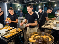 A boy is frying panzerotti for sale during the patronal feast of the Three Saints of Bisceglie, in Bisceglie, on August 11, 2024. Bisceglie...