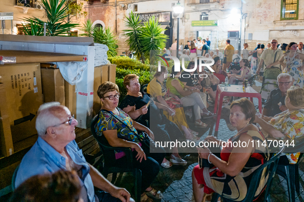 Elderly people are seated to enjoy the procession during the patronal feast of the Three Saints of Bisceglie, in Bisceglie, on August 11, 20...