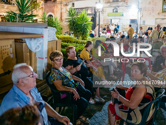 Elderly people are seated to enjoy the procession during the patronal feast of the Three Saints of Bisceglie, in Bisceglie, on August 11, 20...