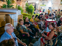 Elderly people are seated to enjoy the procession during the patronal feast of the Three Saints of Bisceglie, in Bisceglie, on August 11, 20...