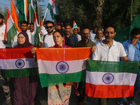 People are holding Indian National flags during the Tiranga Rally ahead of India's Independence Day celebrations in Srinagar, Jammu and Kash...