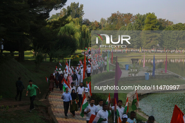 People are taking part in the Tiranga Rally ahead of India's Independence Day celebrations in Srinagar, Jammu and Kashmir, on August 12, 202...