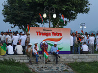 People are sitting on the banks of Dal Lake as they are taking part in the Tiranga Rally ahead of India's Independence Day celebrations in S...