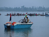 Indian policemen are standing alert on a motorboat during the Tiranga Rally ahead of India's Independence Day celebrations in Srinagar, Jamm...