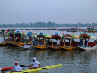 Men are rowing boats as they take part in the Tiranga Rally ahead of India's Independence Day celebrations in Srinagar, Jammu and Kashmir, o...