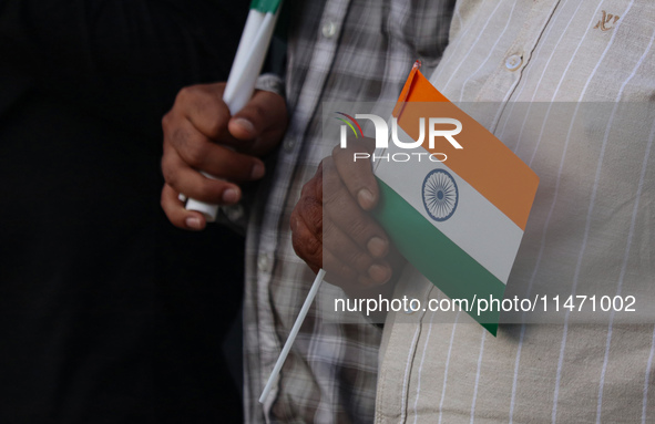 A man is holding the Indian National flag during the Tiranga Rally ahead of India's Independence Day celebrations in Srinagar, Jammu and Kas...