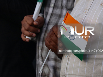 A man is holding the Indian National flag during the Tiranga Rally ahead of India's Independence Day celebrations in Srinagar, Jammu and Kas...