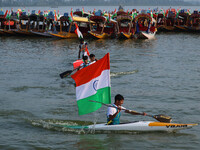 A man is riding a kayak as he takes part in the Tiranga Rally ahead of India's Independence Day celebrations in Srinagar, Jammu and Kashmir,...