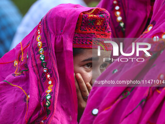 A woman is looking on during the Tiranga Rally ahead of India's Independence Day celebrations in Srinagar, Jammu and Kashmir, on August 12,...