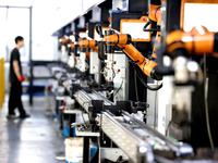 A robot is producing pump products on a production line in Ningde, Fujian province, China, on August 12, 2024. (