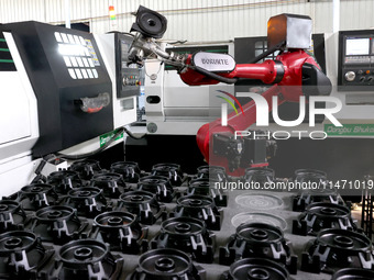 A robot is producing pump products on a production line in Ningde, Fujian province, China, on August 12, 2024. (